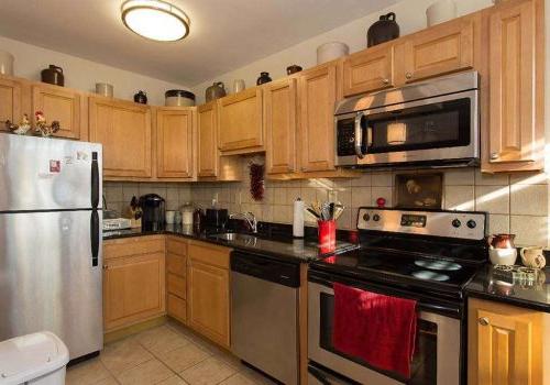 Kitchen with stainless steel appliances at Sedgwick Gardens apartments for rent in Philadelphia, PA
